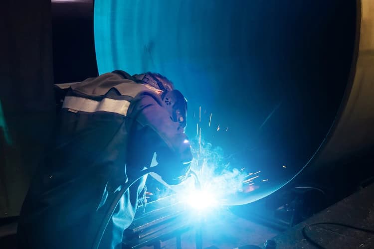Welder welding a large pipe